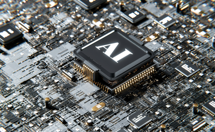 Nahaufnahme eines Computerchips mit der Aufschrift „AI“ auf einer Leiterplatte.